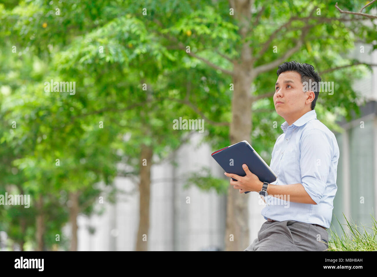 Young Japanese businessman downtown Tokyo Stock Photo