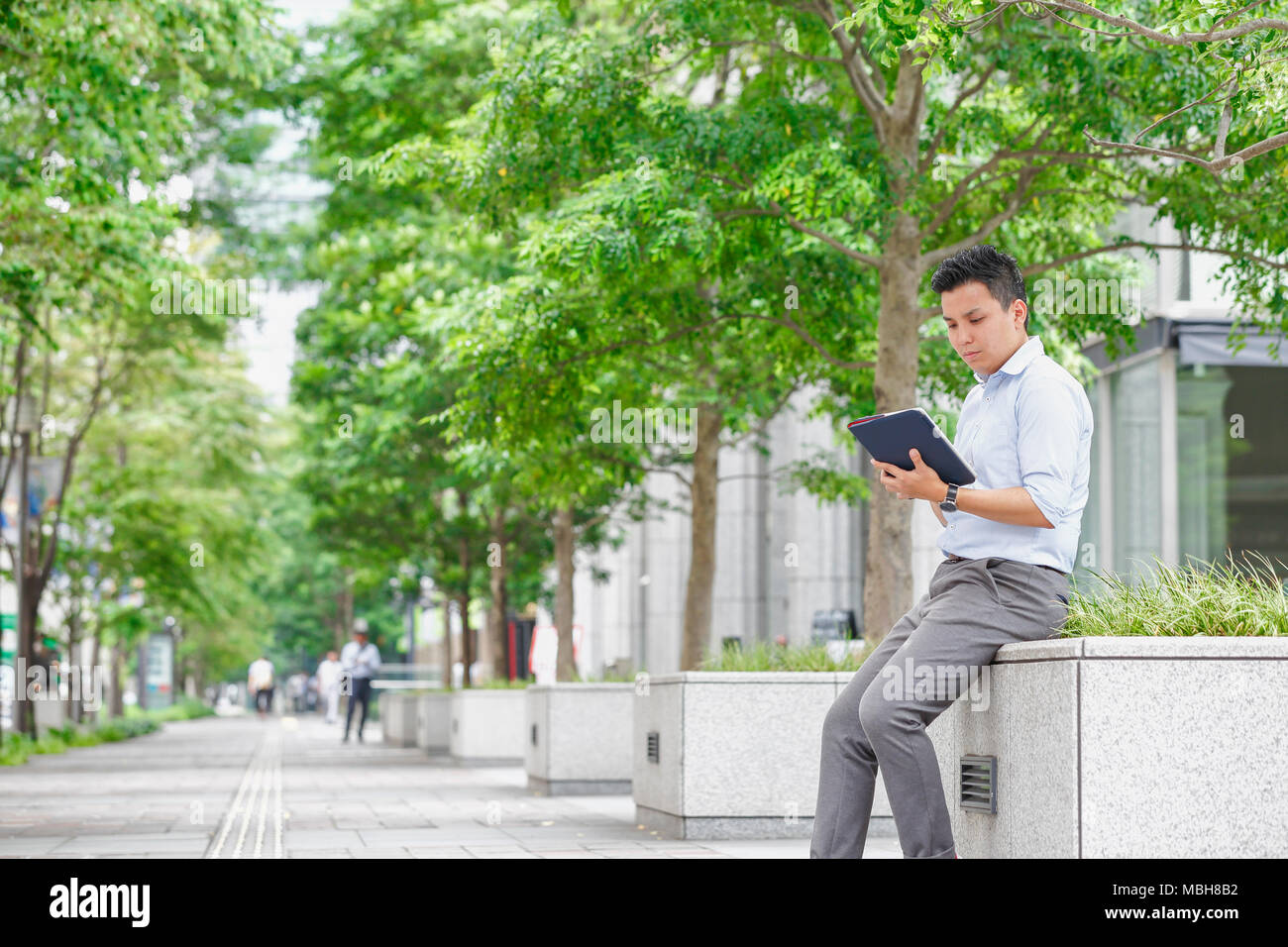 Young Japanese businessman downtown Tokyo Stock Photo