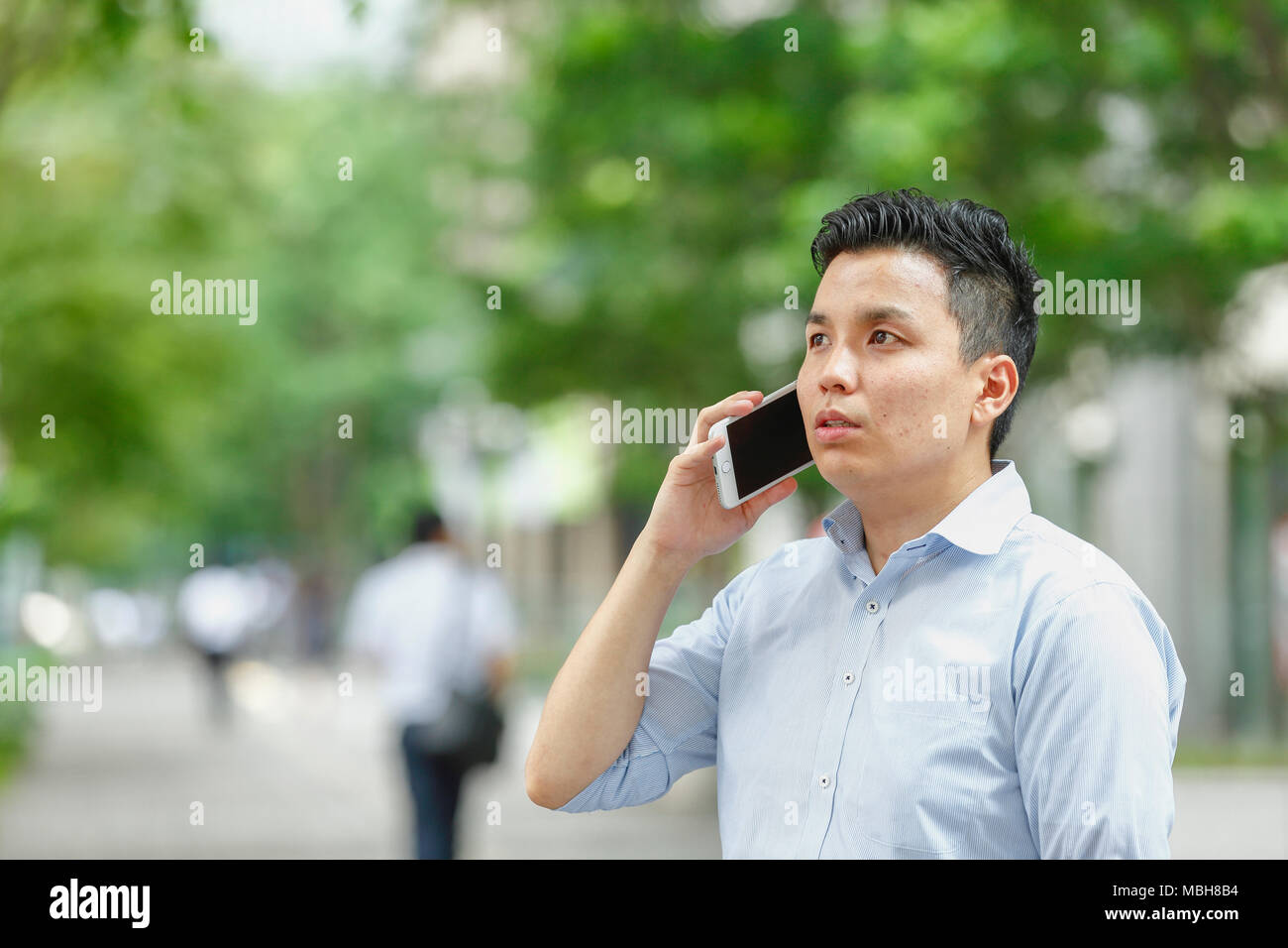 Young Japanese businessman downtown Tokyo Stock Photo