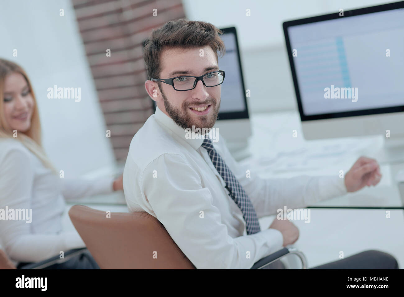 experienced programmer sitting in front of the monitor. office work ...