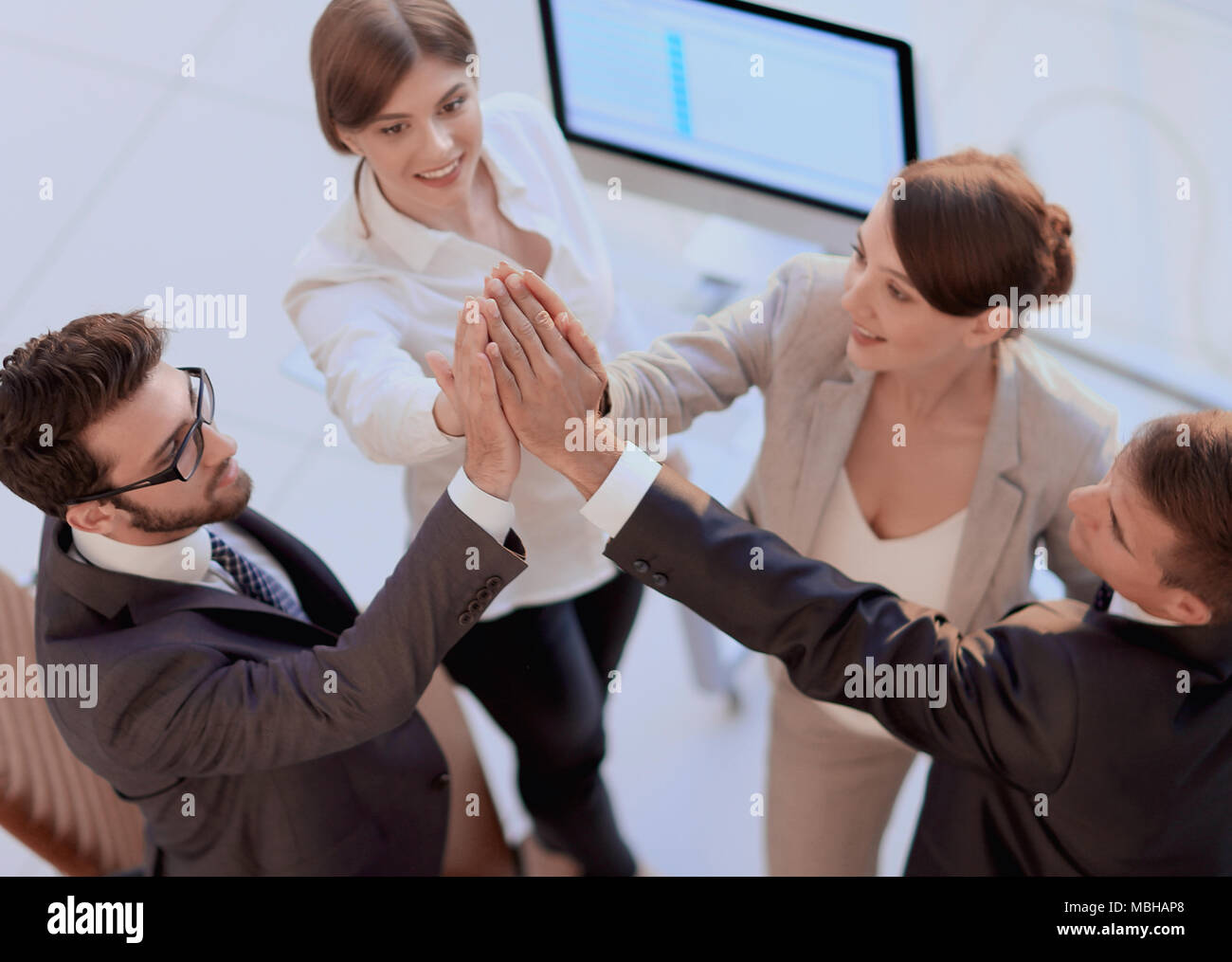 successful business team giving each other a high-five, standing in the ...