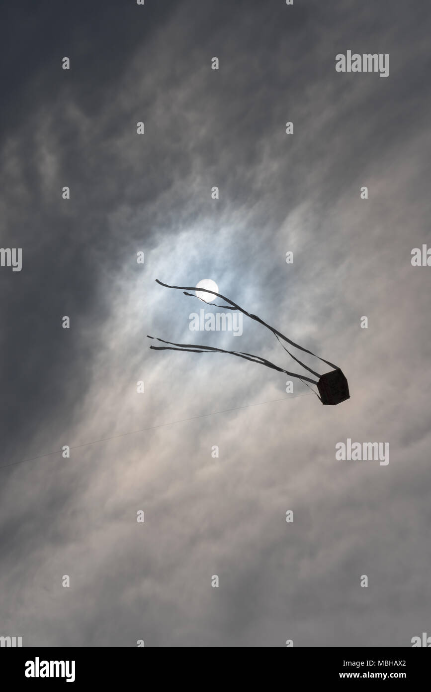 A kite fly against sun and dramatic storm clouds Stock Photo Alamy