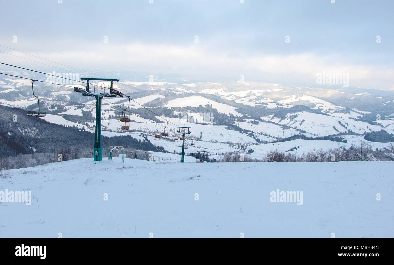Winter mountains panorama with ski slopes and ski lifts. Carpathians mountains, Ukraine. Stock Photo