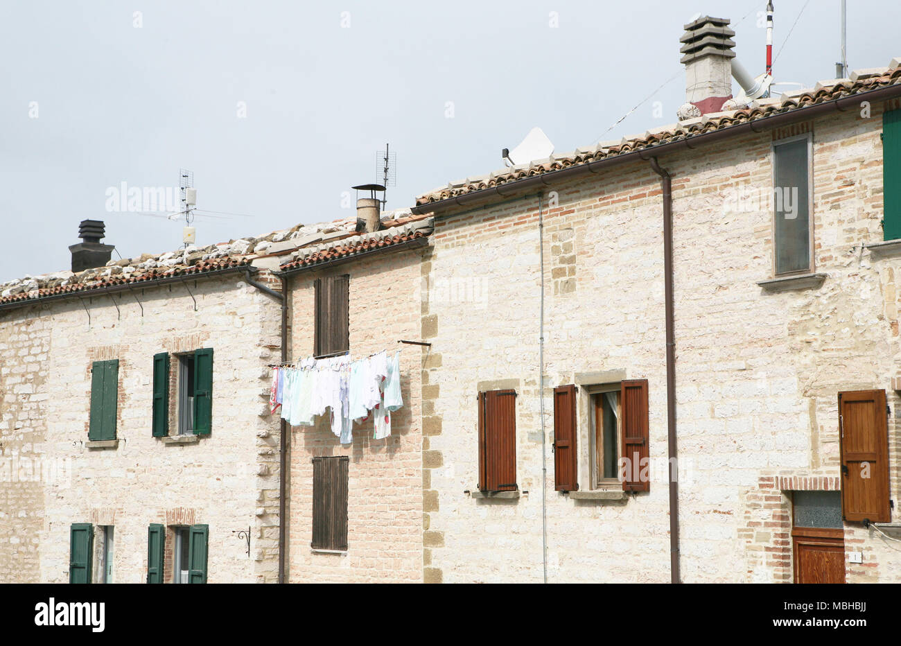 Stone houses with laundry line, Frontone, Italy Stock Photo