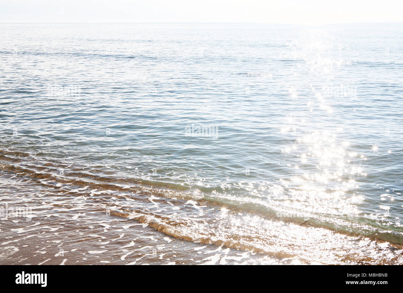 The reflex of sun on the sea shore Stock Photo