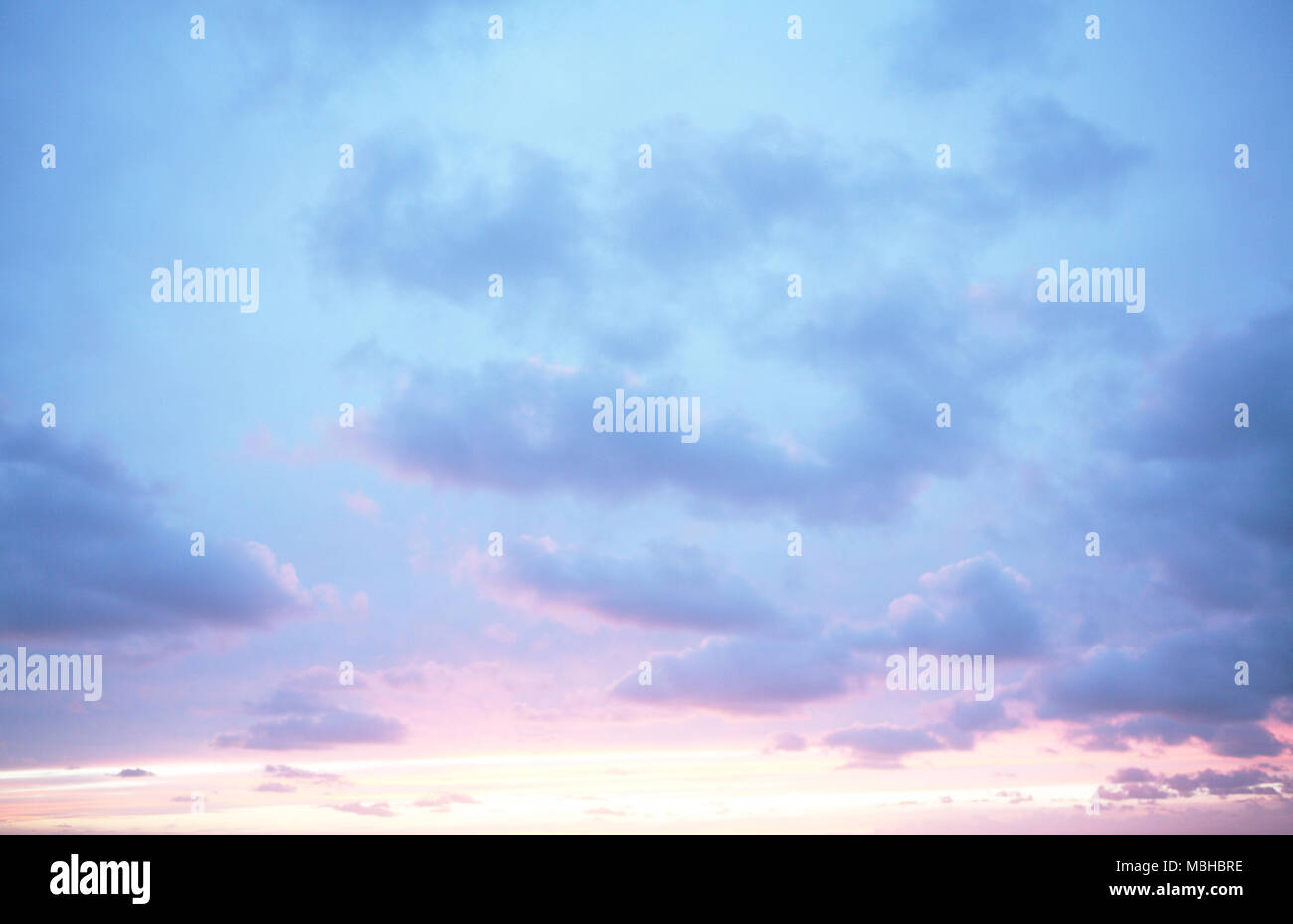 Red Sunset sky with blue clouds Stock Photo