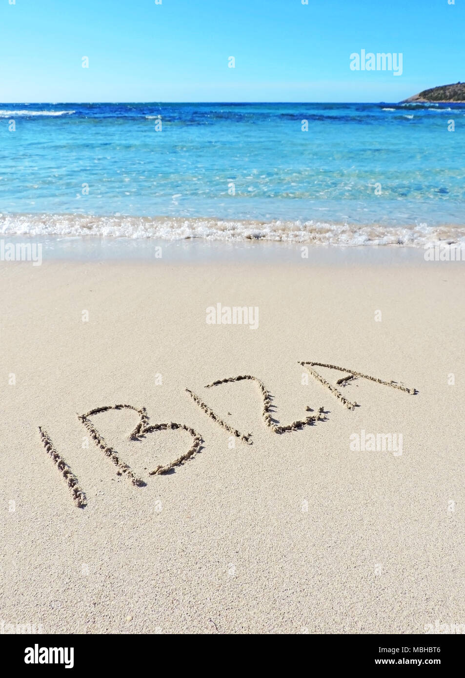 Ibiza text, drawing in the sand. Travel destination, beach holidays on Ibiza Island. Stock Photo