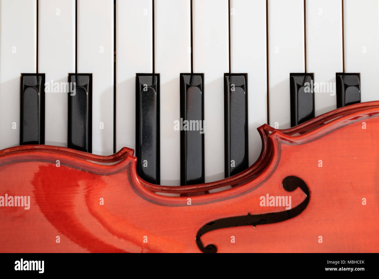classical violin on white and black piano keys close-up background Stock Photo