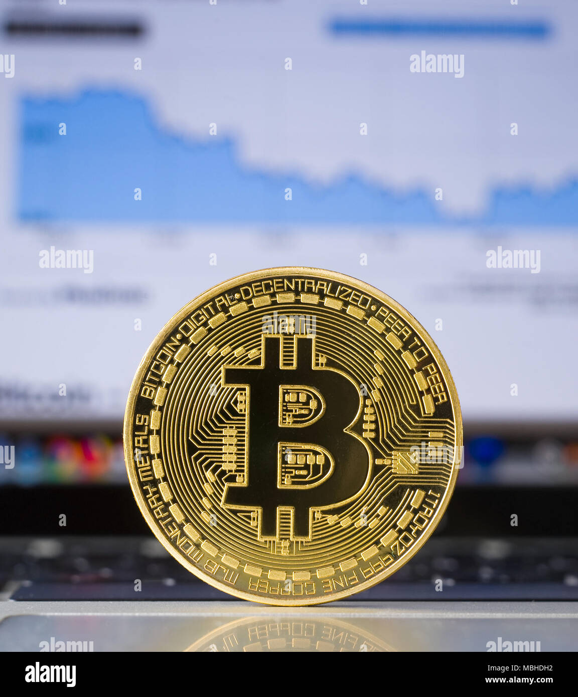 Bitcoin on a laptop with price trend graffic on the background Stock ...
