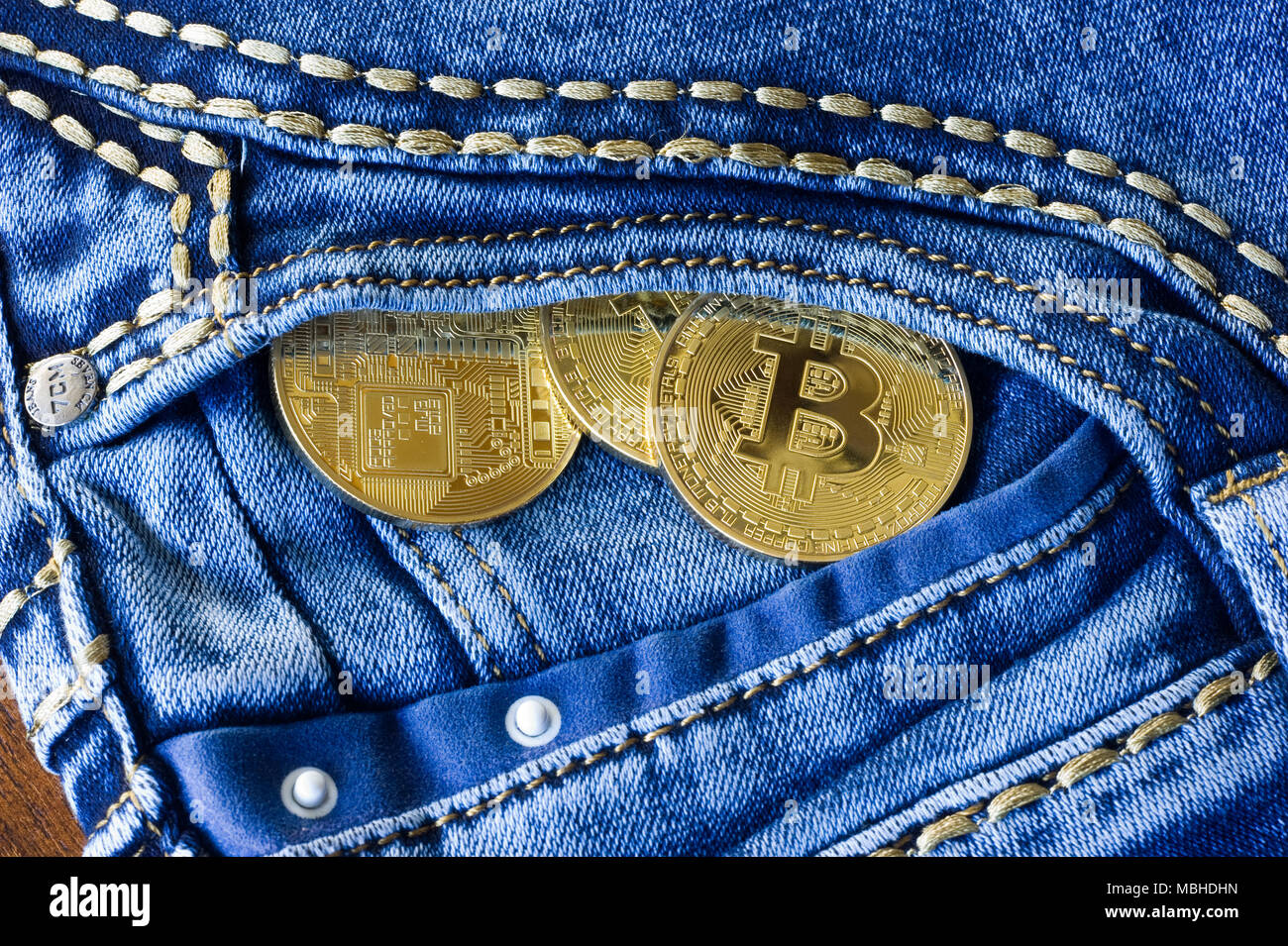 Bitcoins in the pocket of a jeans Stock Photo