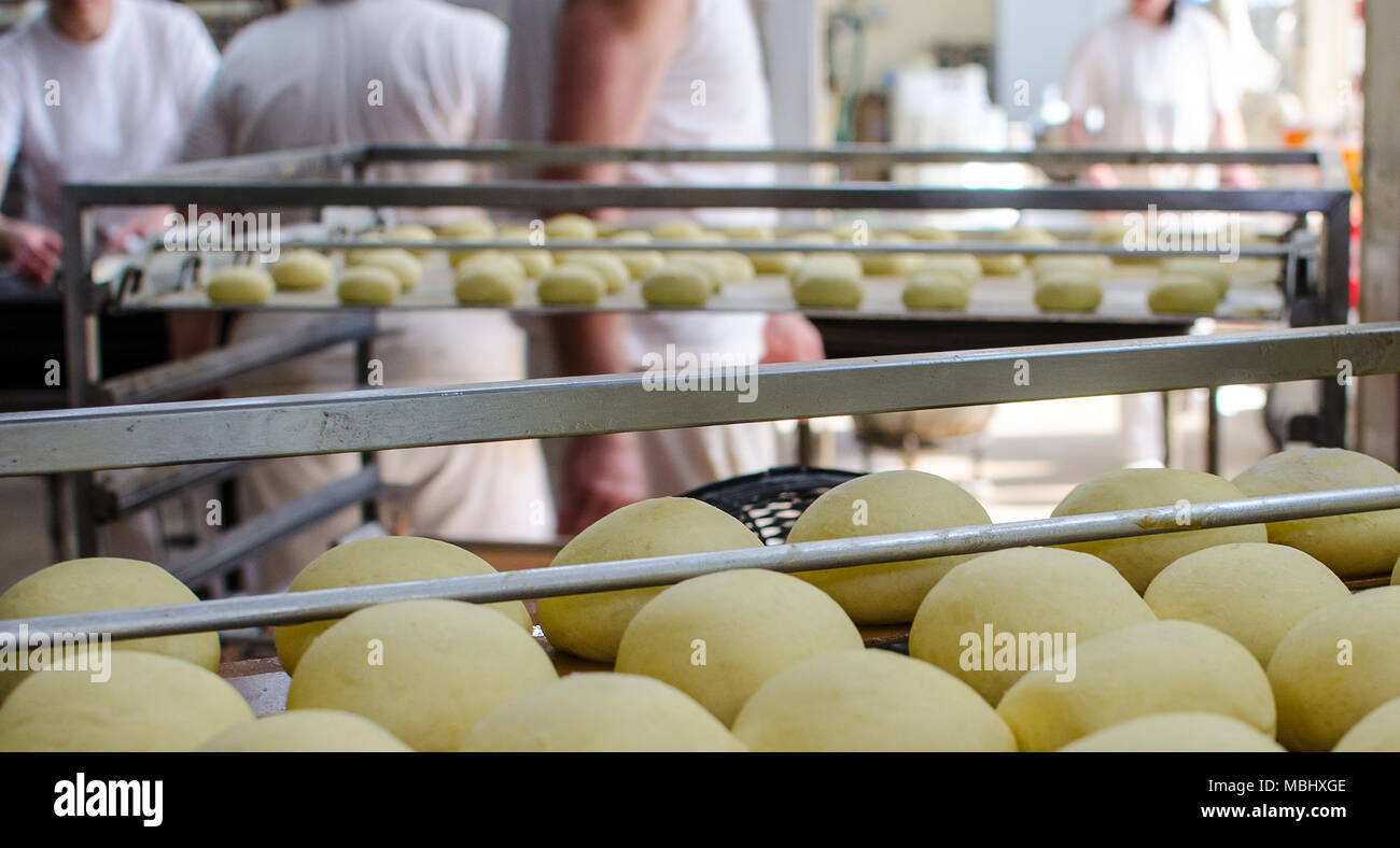Working on a sweet pastry in a big industrial bakery. Stock Photo