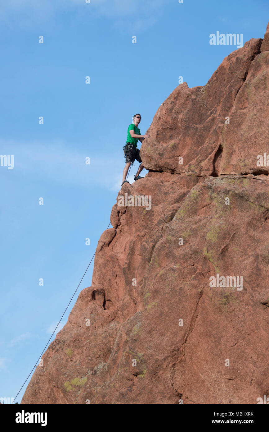 Rock Climber man climbing sandstone cliffs in Garden of The Gods April 4, 2016 Stock Photo