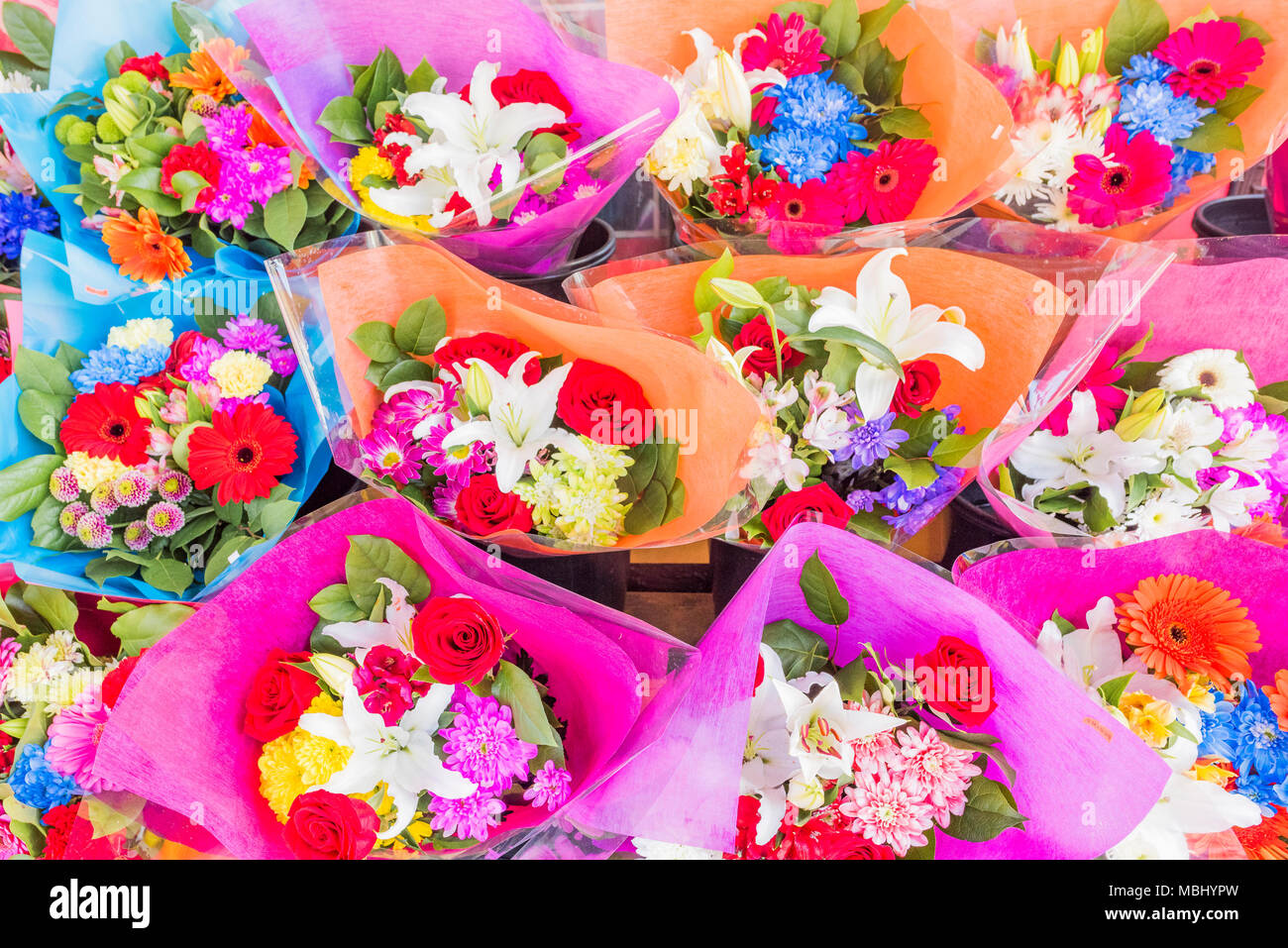 Bouquets of flowers for sale outside convenience store Stock Photo Alamy