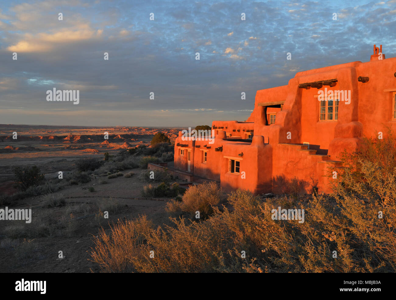 Late-afternoon sun shines on the Painted Desert Inn in Petrified Forest National Park, Arizona. The national historic landmark is now a museum. Stock Photo