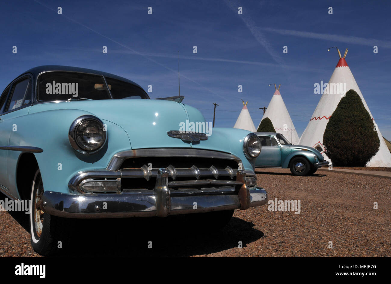 Classic cars are displayed at the Wigwam Motel in Holbrook, Arizona. The Route 66 landmark opened in 1950 and is one of three surviving Wigwam motels. Stock Photo