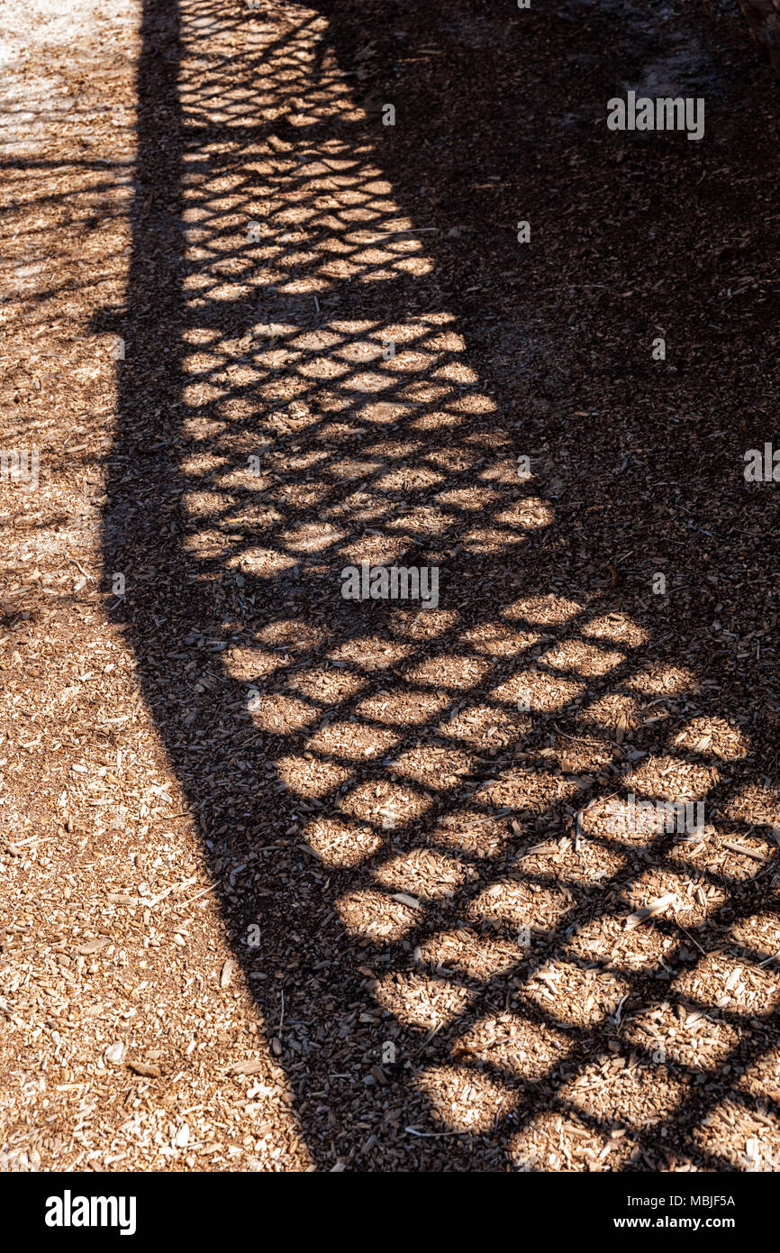 Fence creates interesting abstract shadows; National Historic District; Salida; Colorado; USA Stock Photo