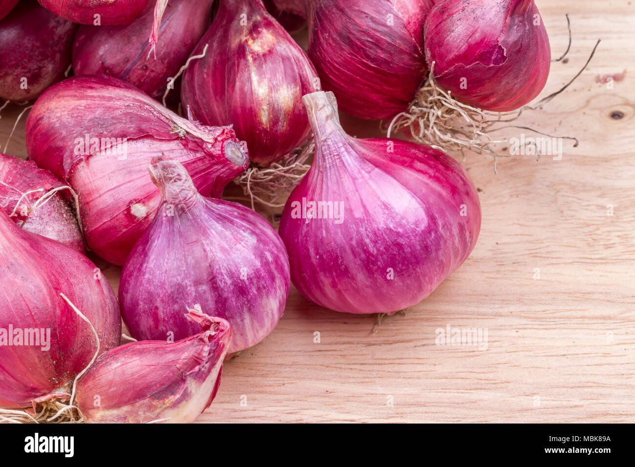 piles of shallots vegetable on wooden background Stock Photo