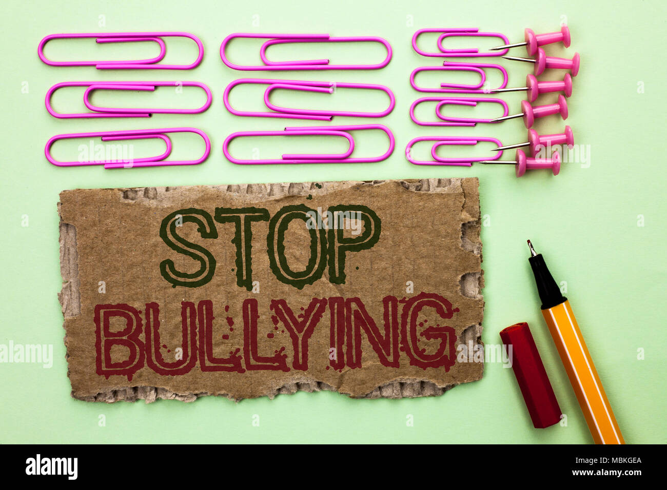 Handwriting text writing Stop Bullying. Concept meaning Do not continue Abuse Harassment Aggression Assault Scaring written Tear Cardboard Piece plain Stock Photo