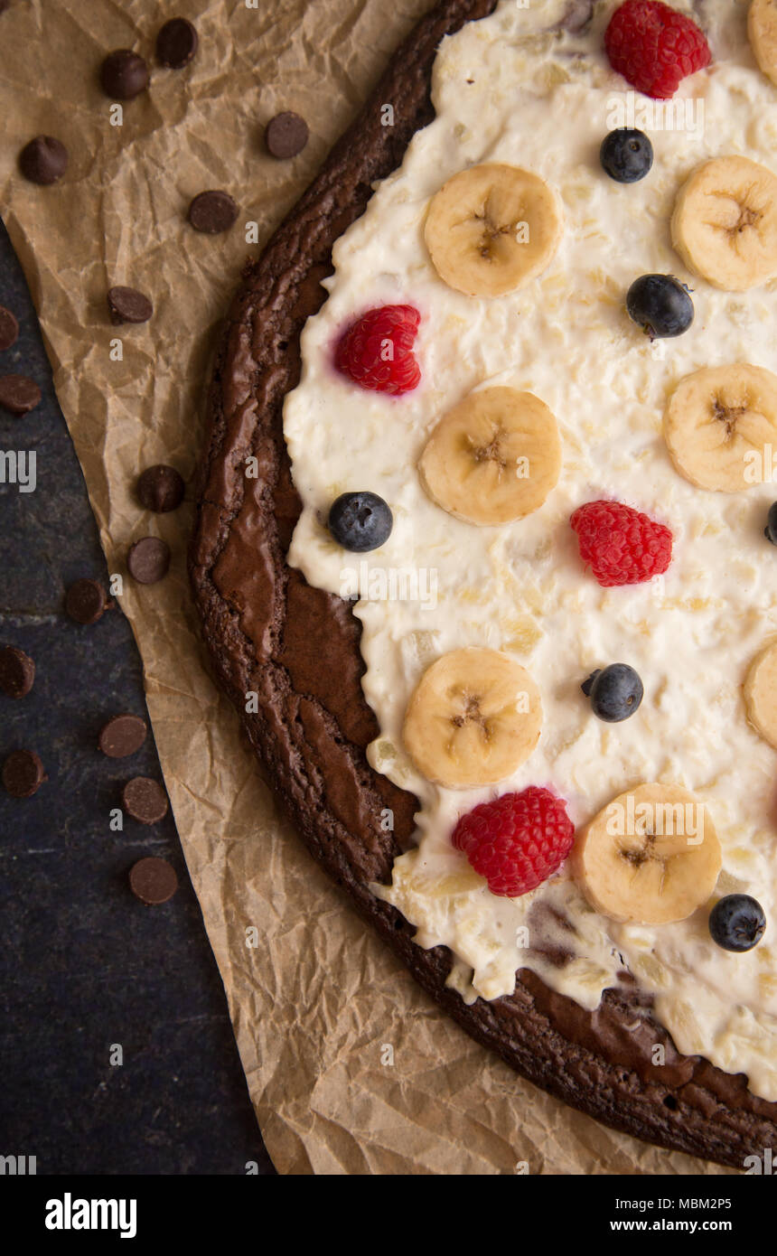 Brownie Dessert Pizza Topped with Fruits and Cream Cheese Frosting