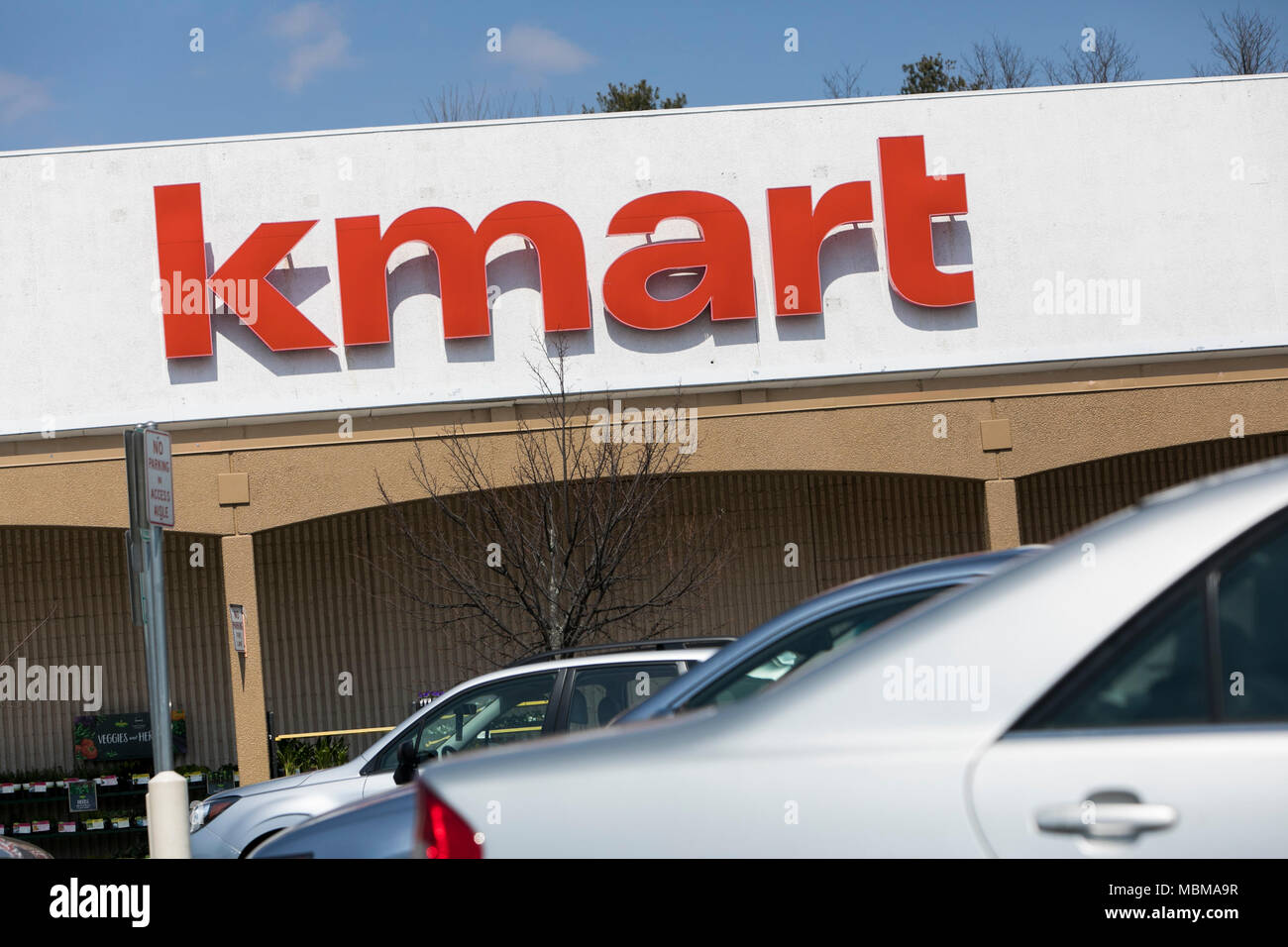 A logo sign outside of a Kmart retail store location in Silver Spring