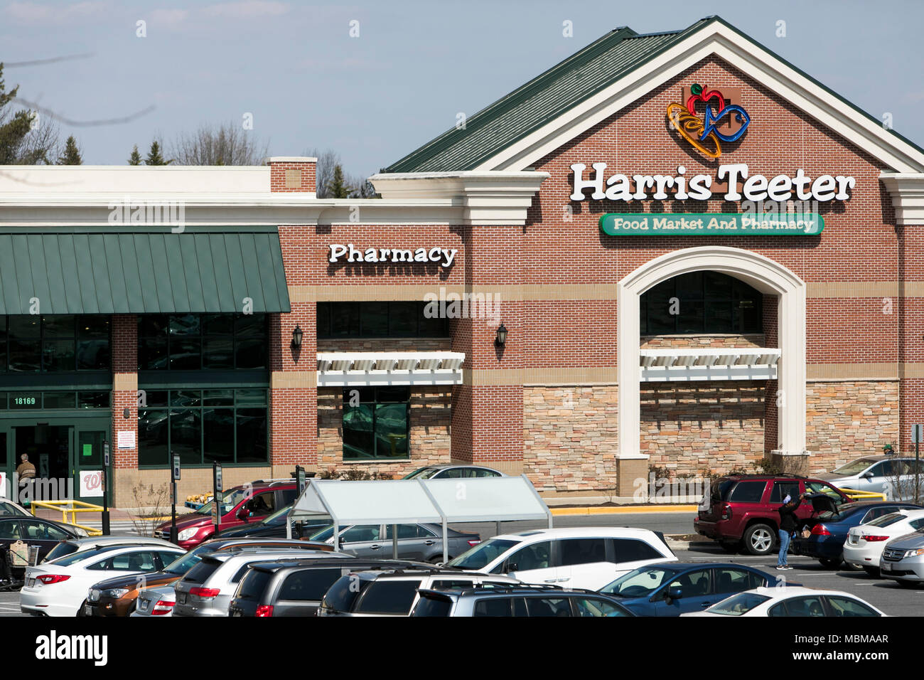 A logo sign outside of a Harris Teeter grocery retail store location in