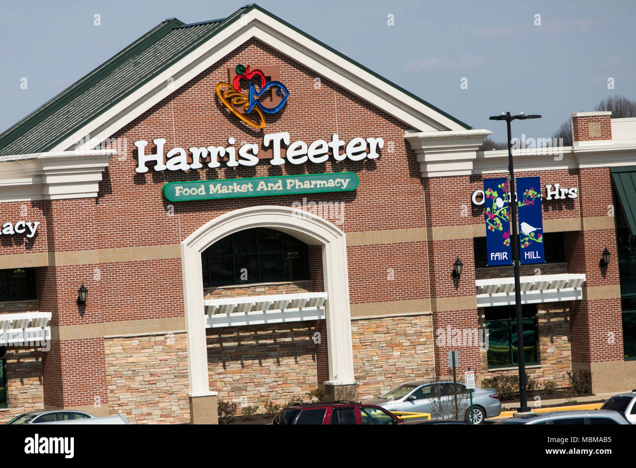 A logo sign outside of a Harris Teeter grocery retail store location in