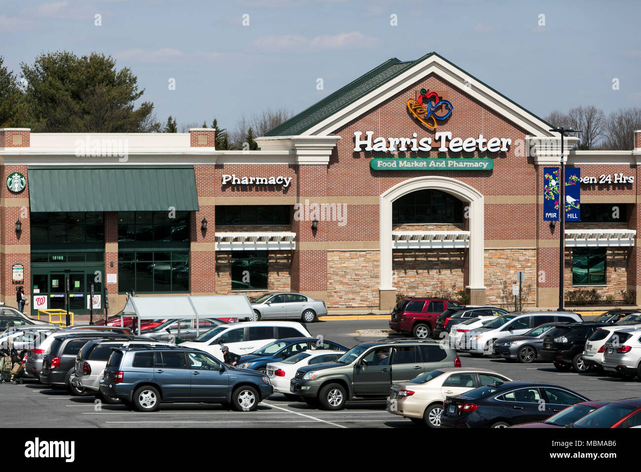 A logo sign outside of a Harris Teeter grocery retail store location in