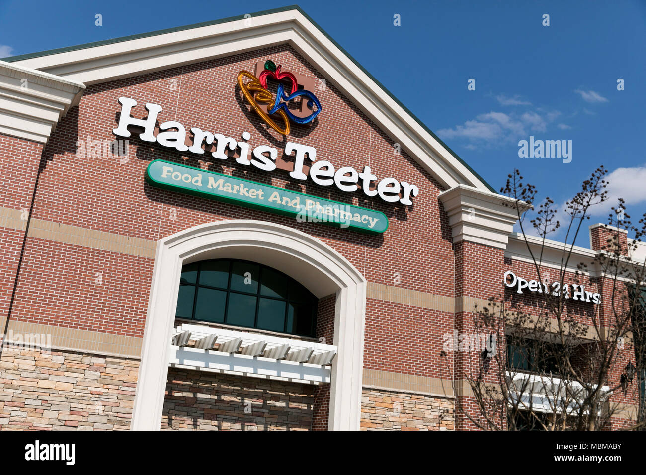 A logo sign outside of a Harris Teeter grocery retail store location in Olney, Maryland on April