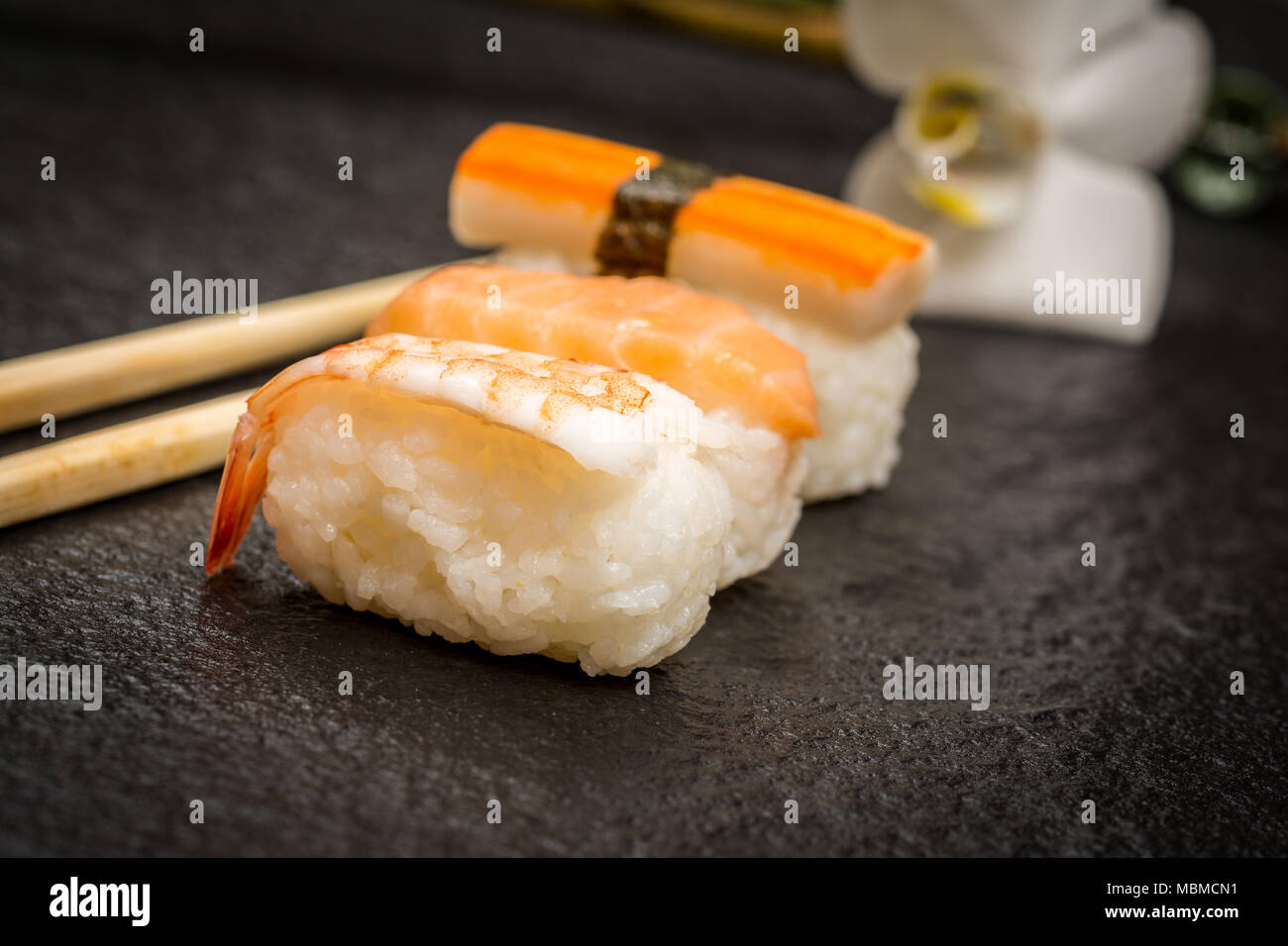 Traditional japanese sushi  nigiri  and chopsticks on stone desk Stock Photo