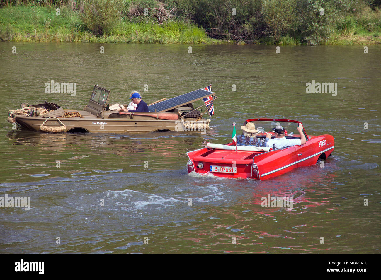 Amphic car and military amphibious vehicle on Moselle river at Cochem, Rhineland-Palatinate, Germany Stock Photo