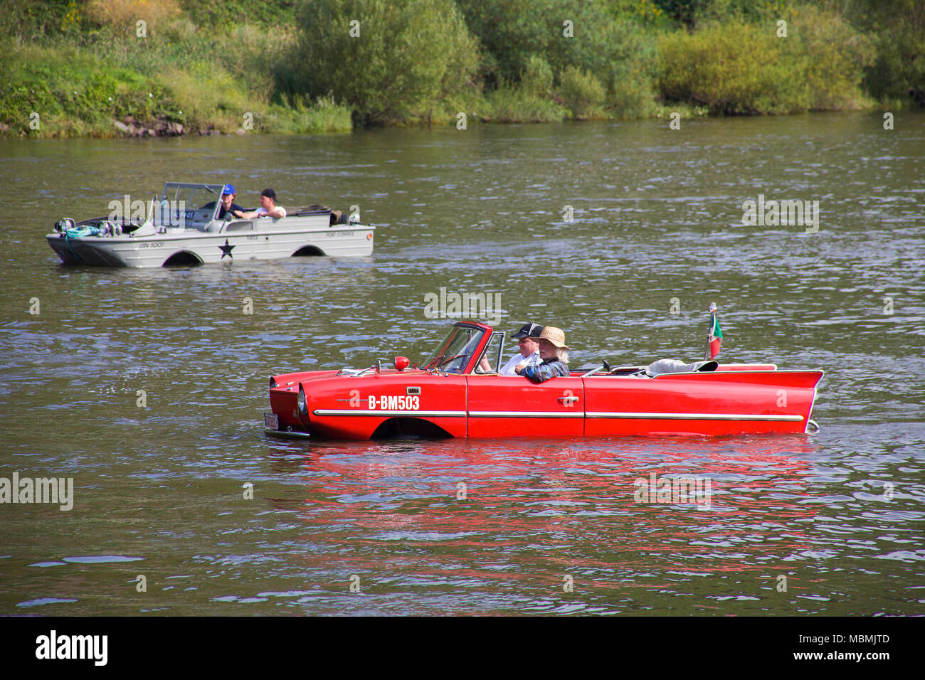 Amphic car and military amphibious vehicle on Moselle river at Cochem, Rhineland-Palatinate, Germany Stock Photo