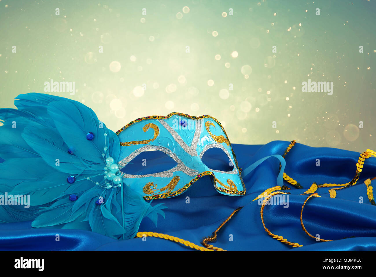Image of elegant blue and gold venetian mask over blue silk fabric ...