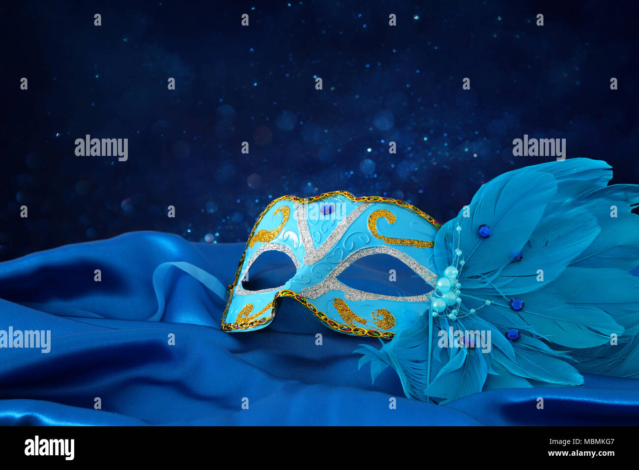 Image of elegant blue and gold venetian mask over blue silk fabric ...