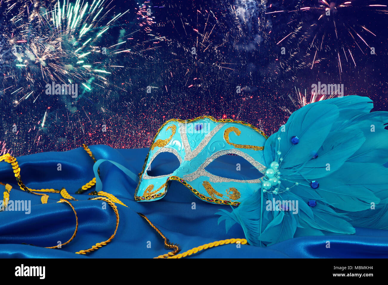 Image of elegant blue and gold venetian mask over blue silk fabric ...