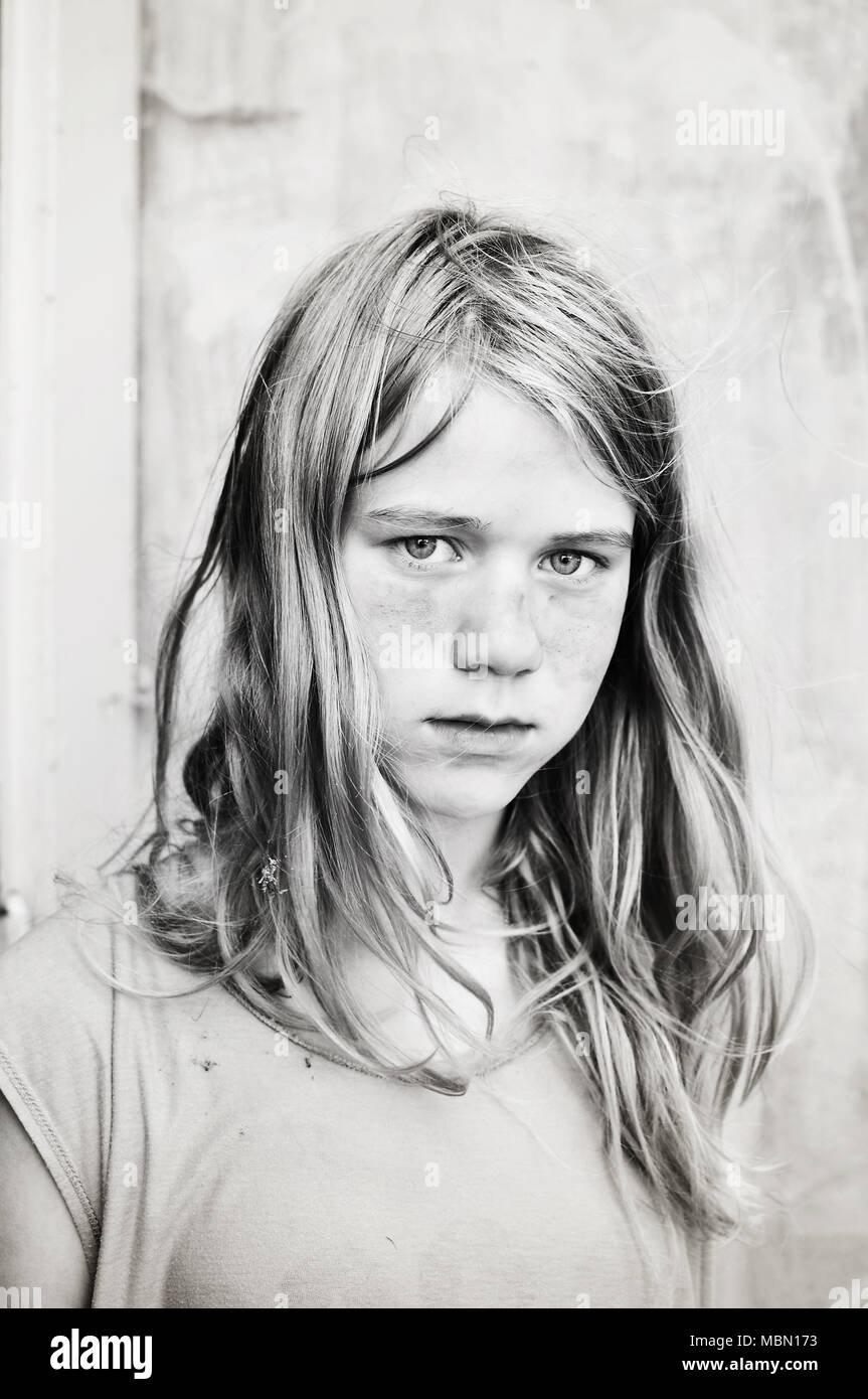 Black and white portrait of serious, dirty girl. Stock Photo