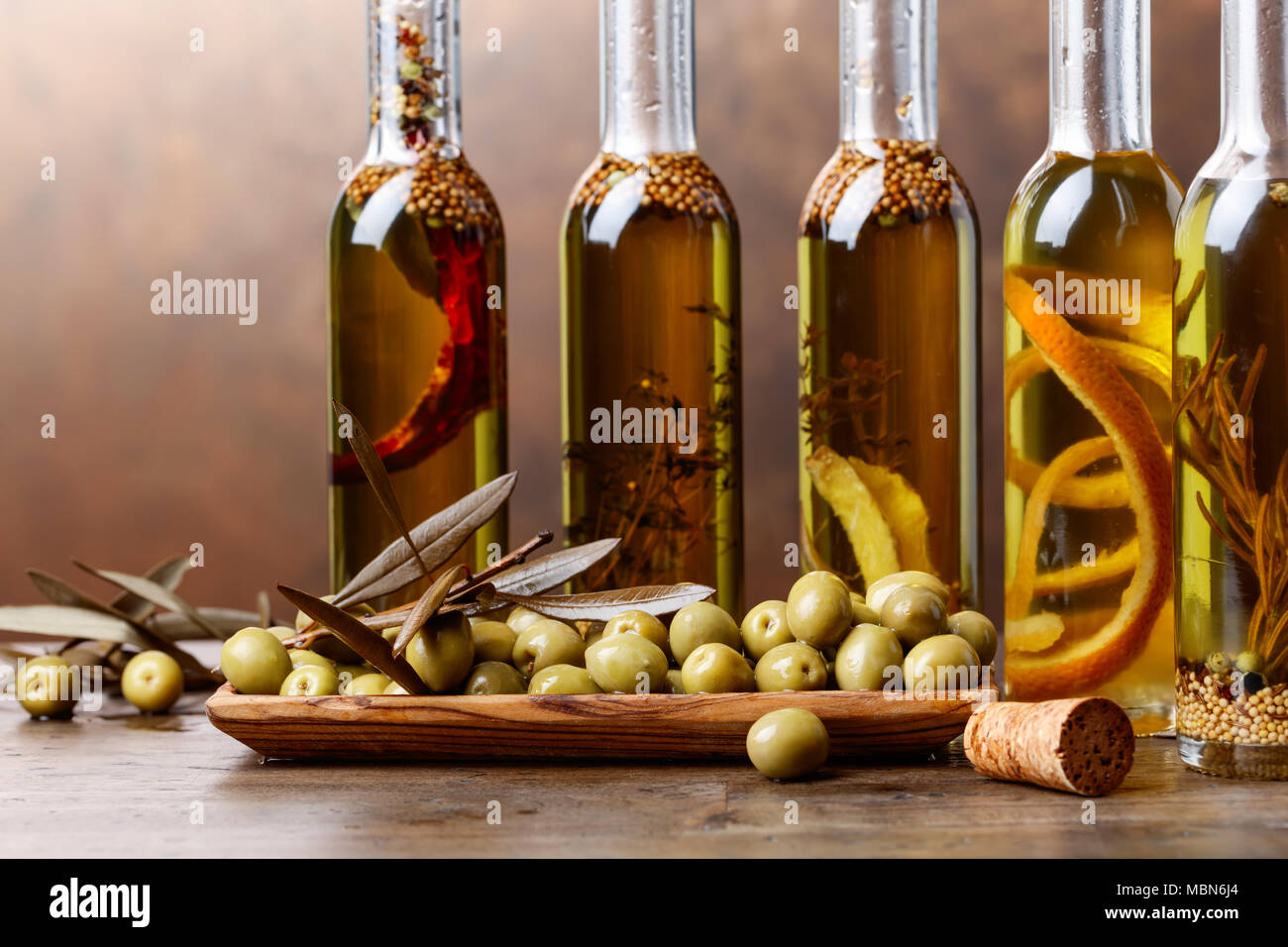 Green olives and bottles of olive oil with spices and herbs Stock Photo ...