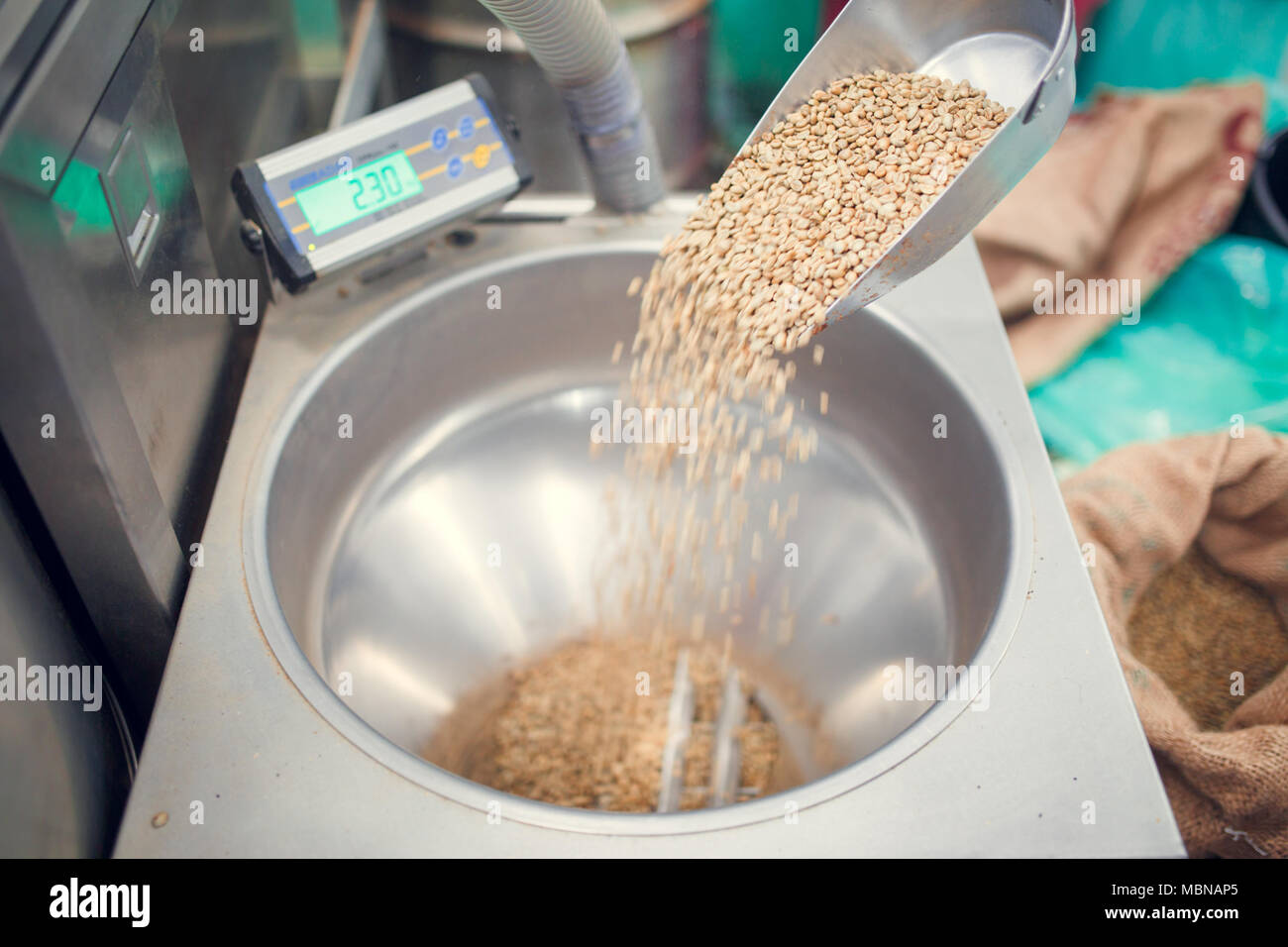 Photo of scoop with coffee beans, industrial scales Stock Photo Alamy