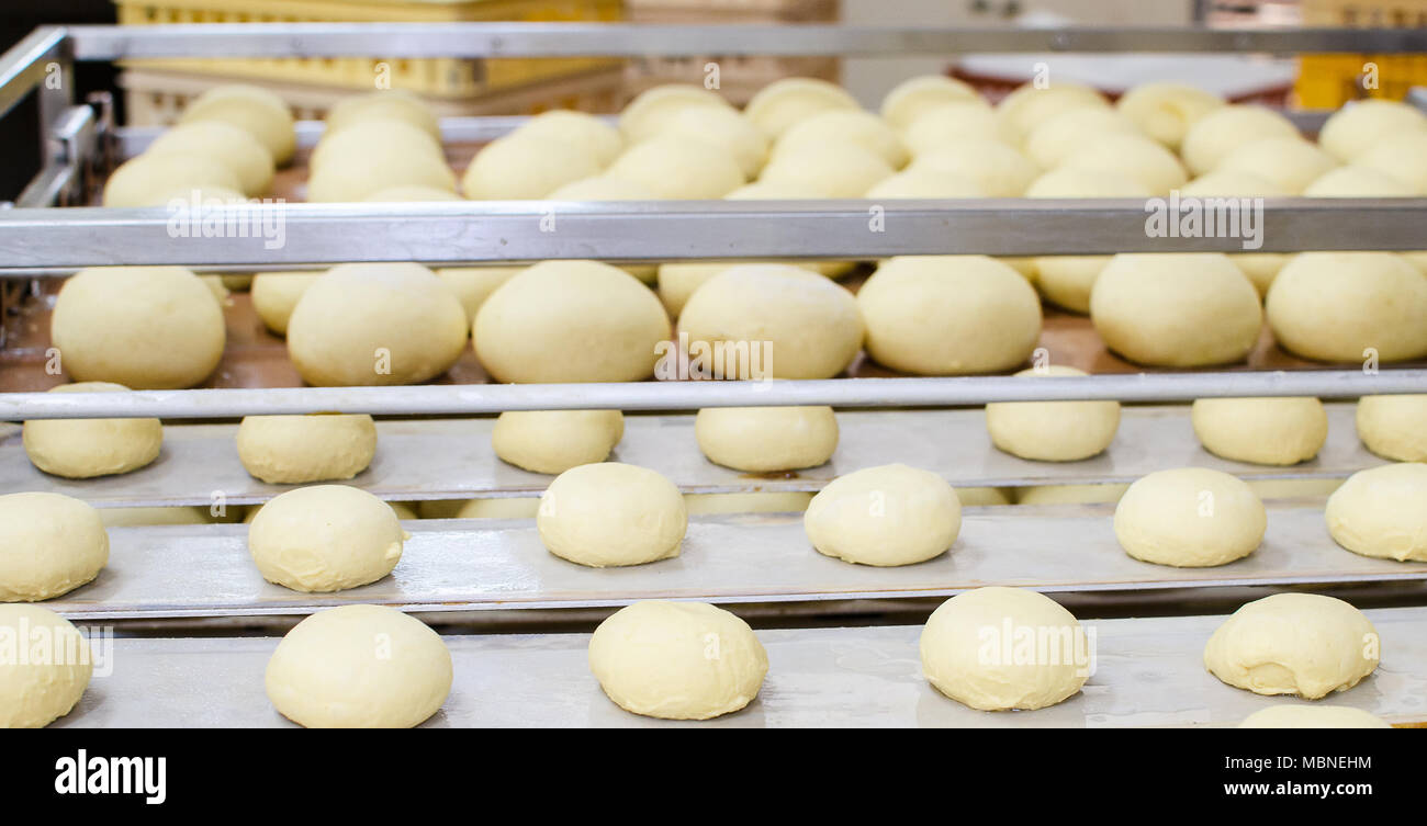 Preparation of donuts. Roasting in boiling oil. Cookng, fried. Stock Photo