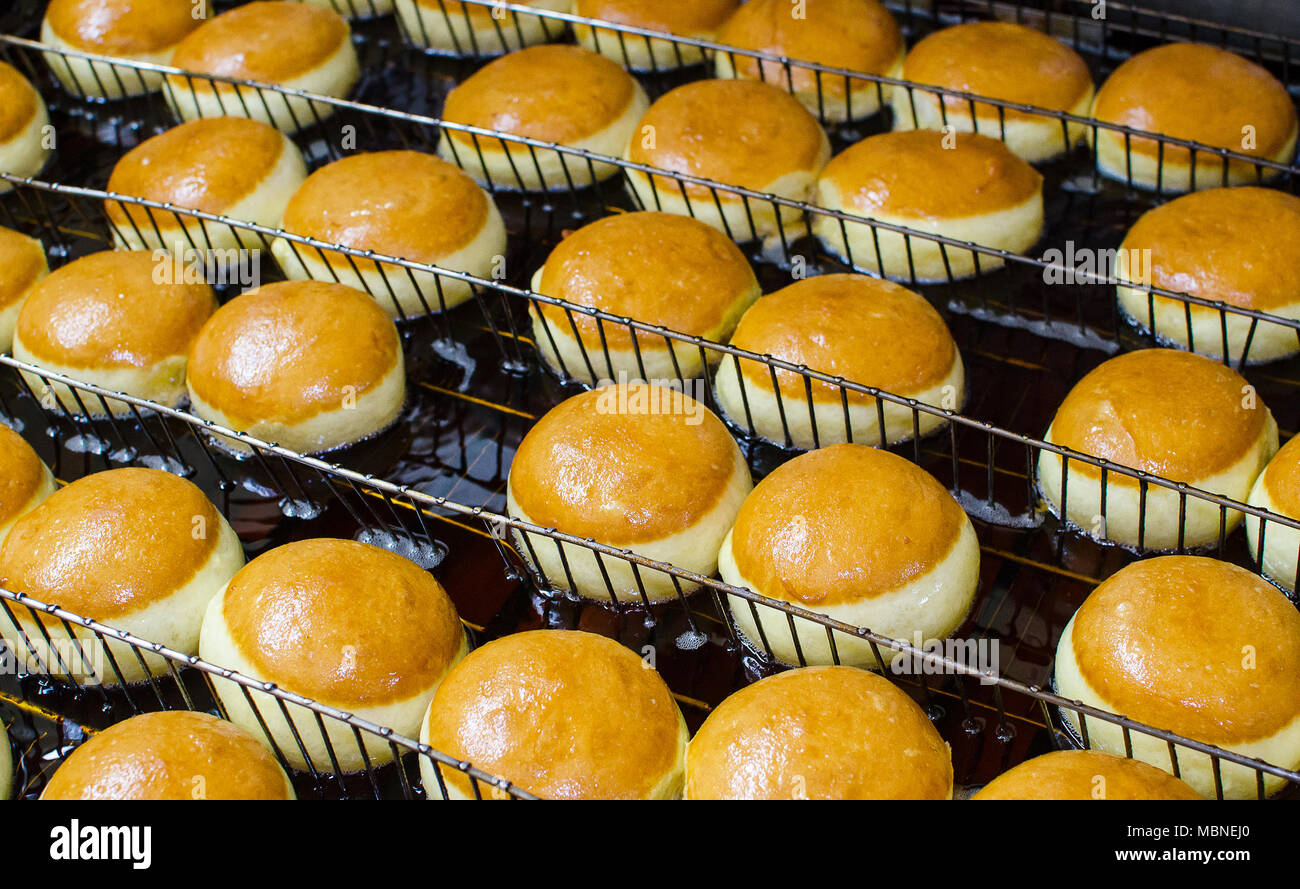 Preparation of donuts. Roasting in boiling oil. Cookng, fried. Stock Photo