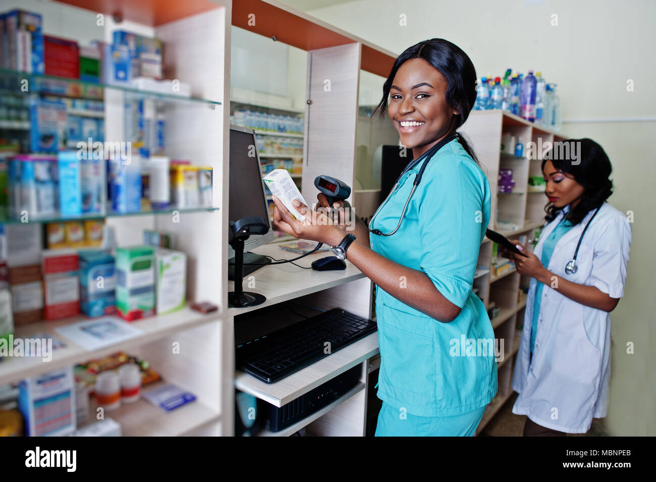 Two african american pharmacist working in drugstore at hospital