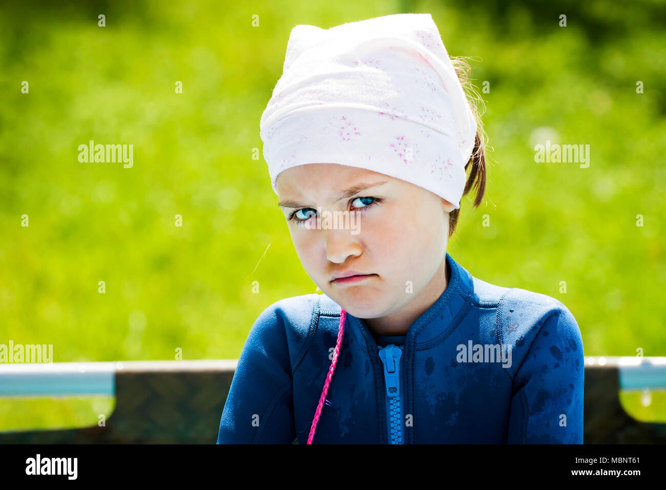 Portrait of girl with angry upset face expression, outdoor. Stock Photo