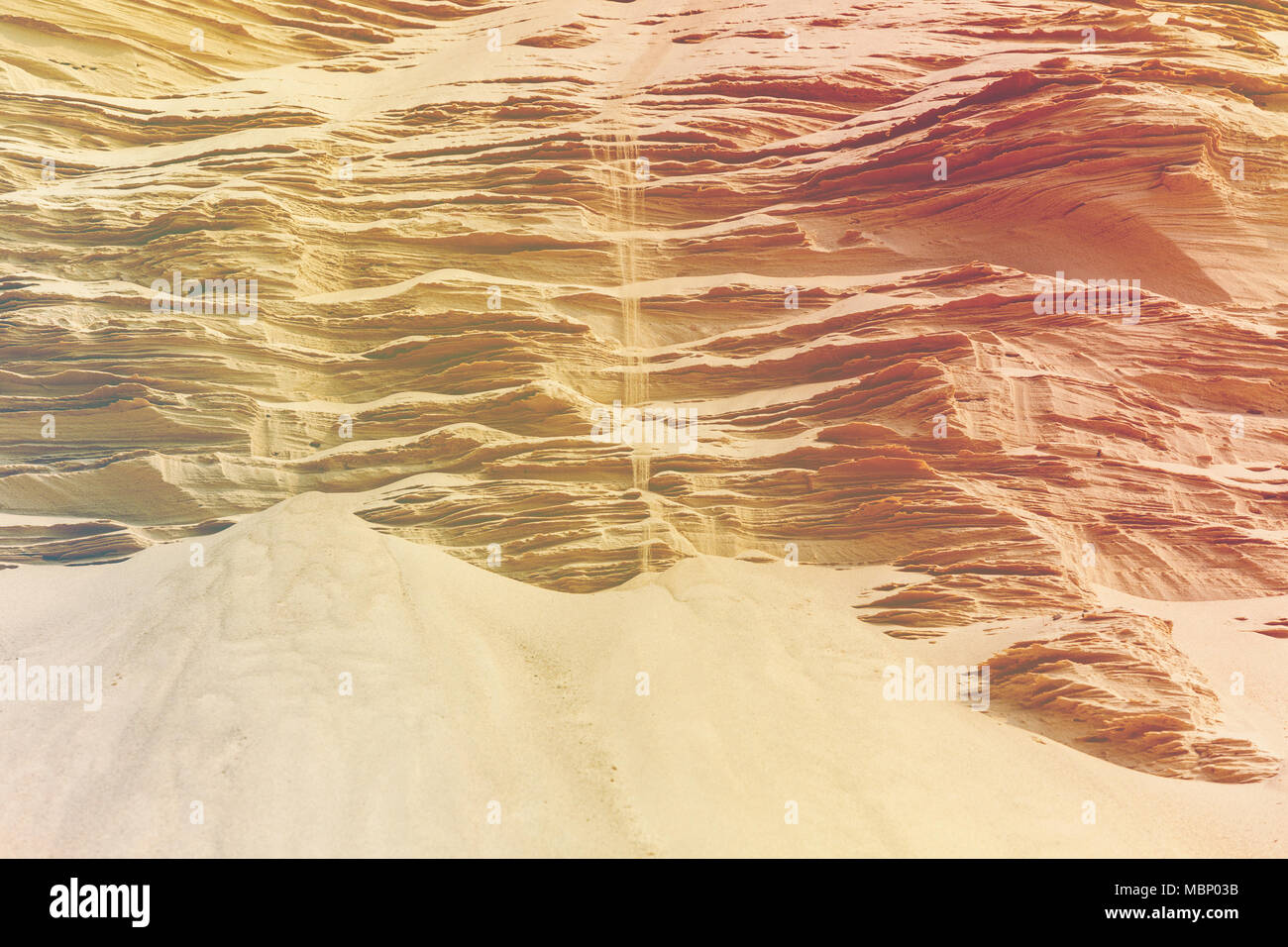 jet of sand falls down on the sand sculptured mountains beautiful natural landscape Stock Photo