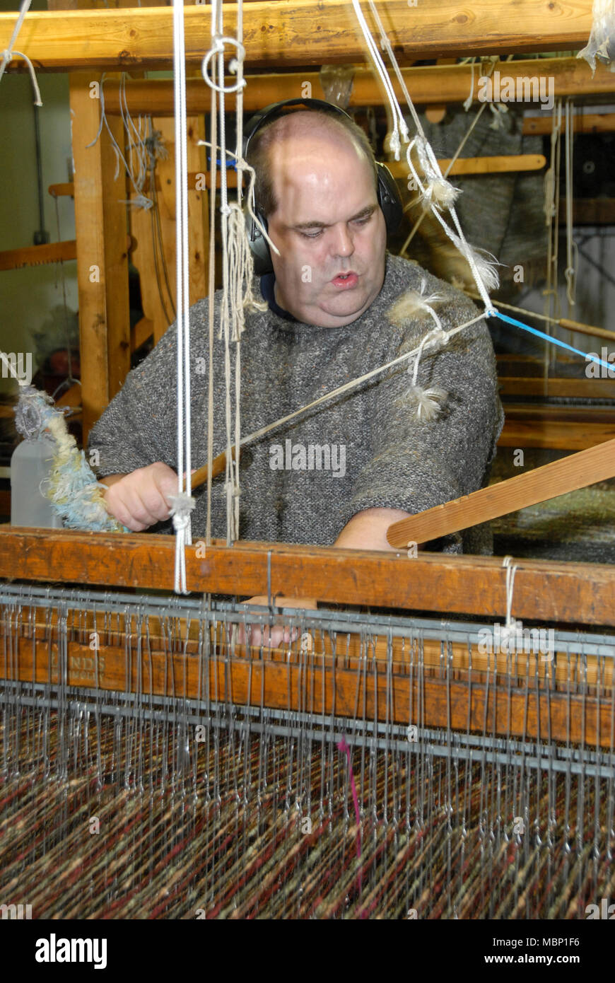 A skilled hand weaver operating a 110yearold Fly Shuttle Loom at the