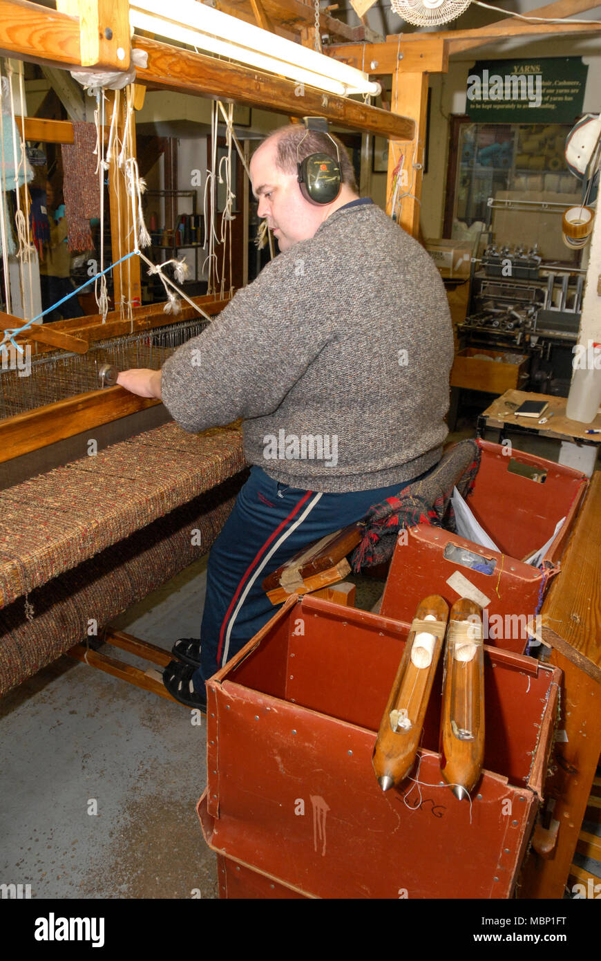 A skilled hand weaver operating a 110yearold Fly Shuttle Loom at the