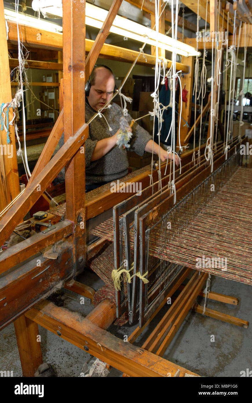 A skilled hand weaver operating a 110yearold Fly Shuttle Loom at the