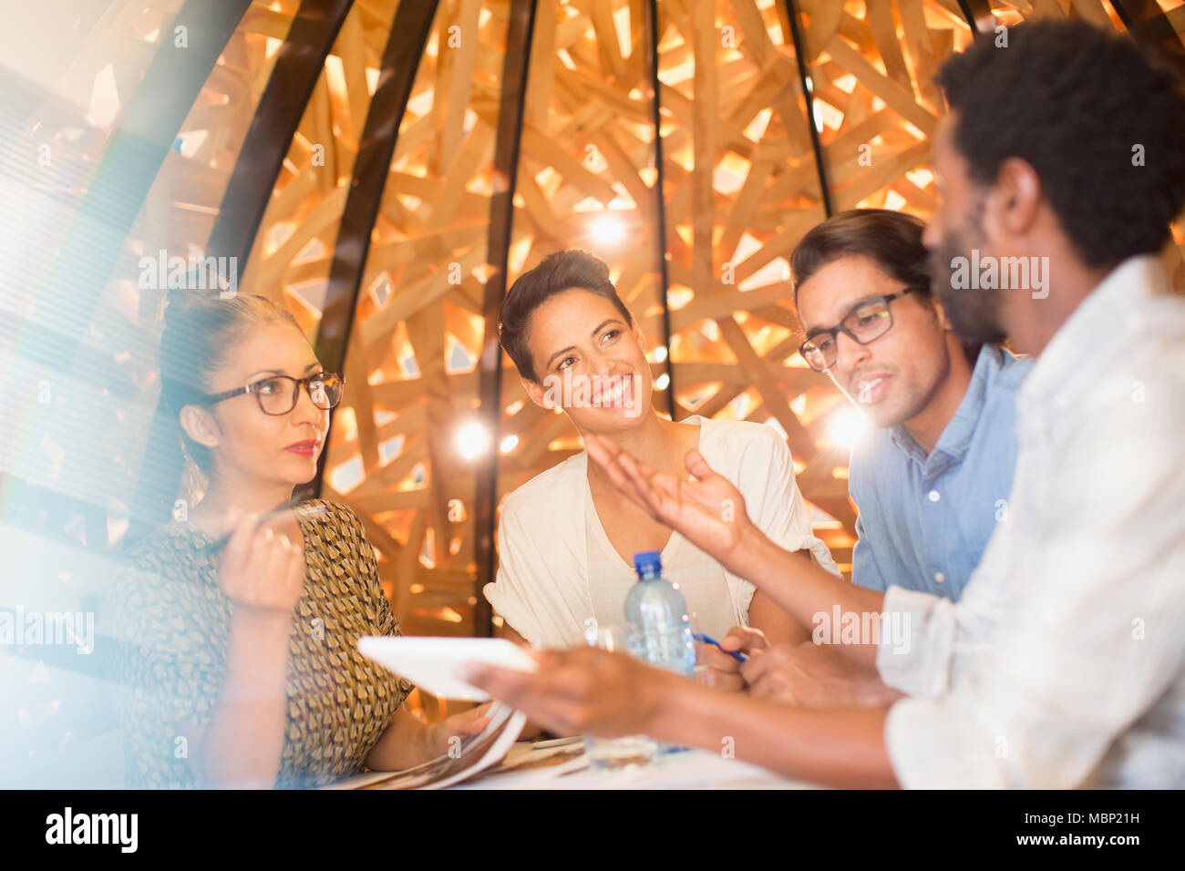 Creative business people with digital tablet talking in meeting Stock Photo