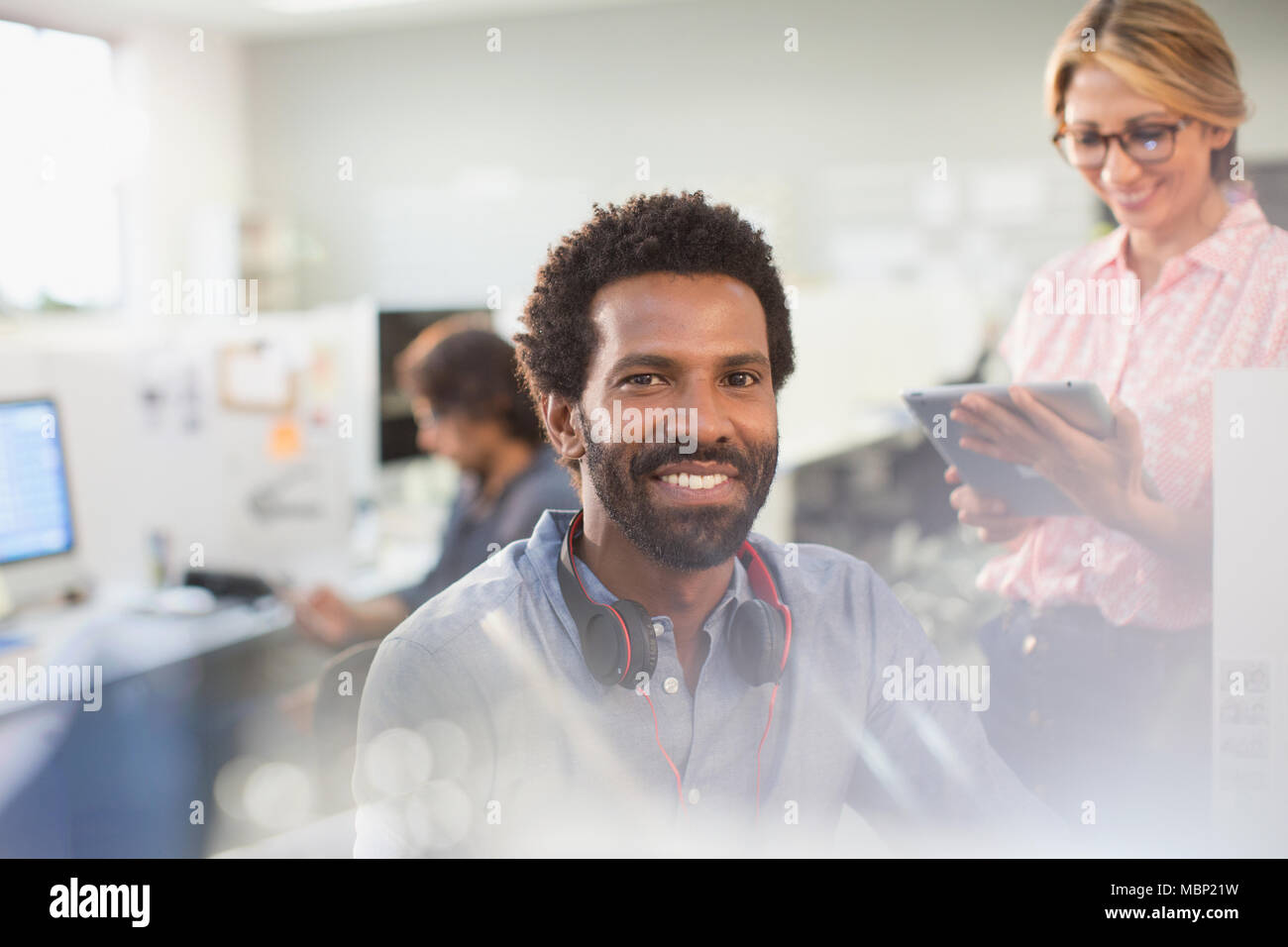 Portrait smiling, confident creative businessman with headphones in office Stock Photo