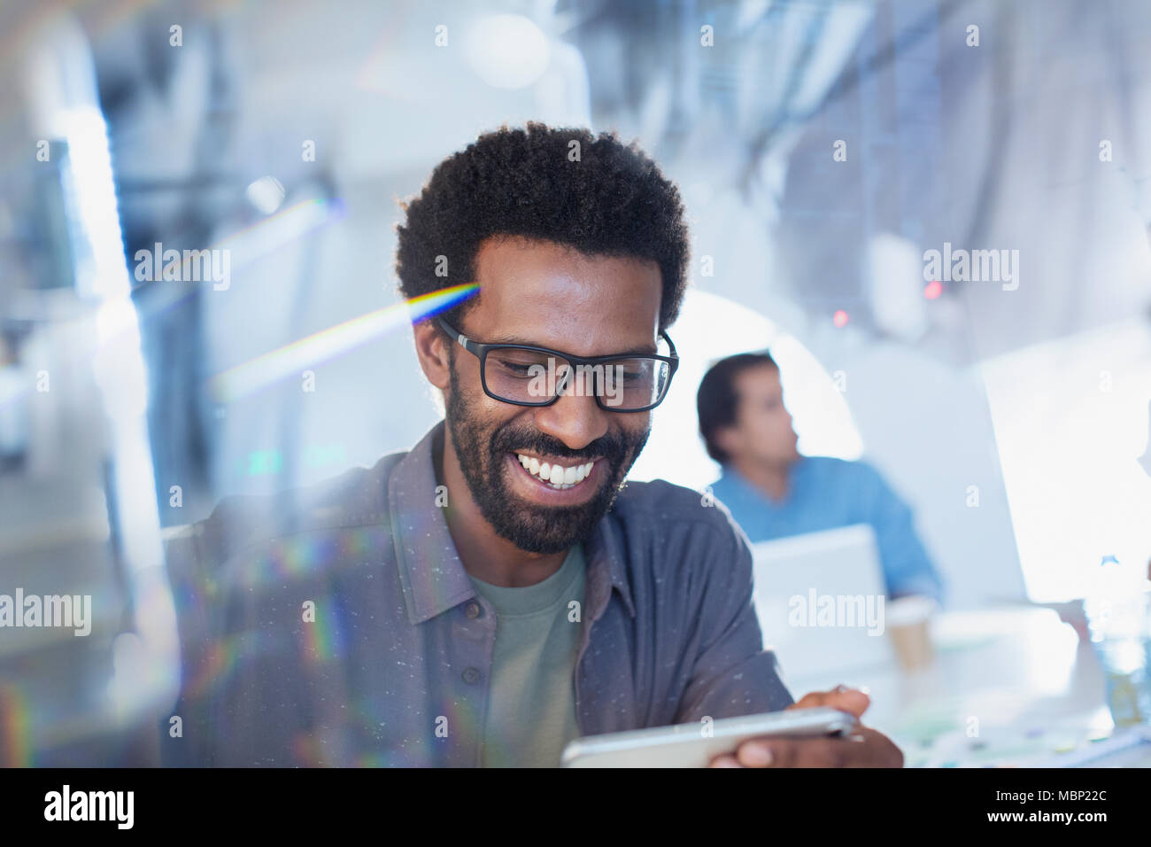 Smiling, confident businessman using digital tablet Stock Photo