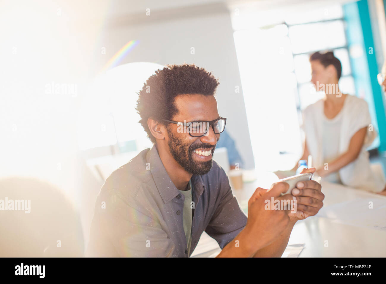 Smiling businessman using smart phone Stock Photo