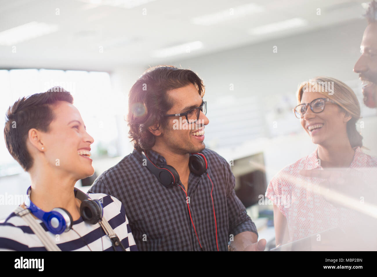 Smiling creative business people talking in office Stock Photo